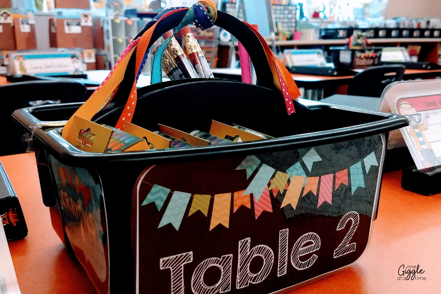 table signs and buckets for classroom supplies